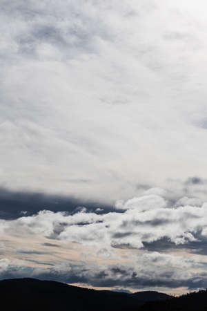 bright white and contrasty clouds formation coming and going across a stormy sky shot in winter