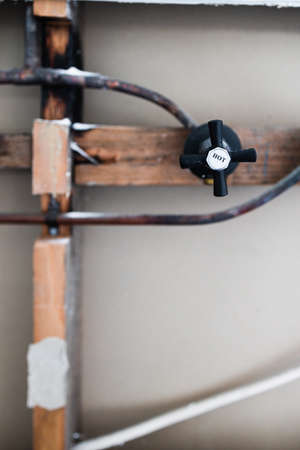 laundry room renovation with plaser walls interior exposed with visible electricity wires and copper...