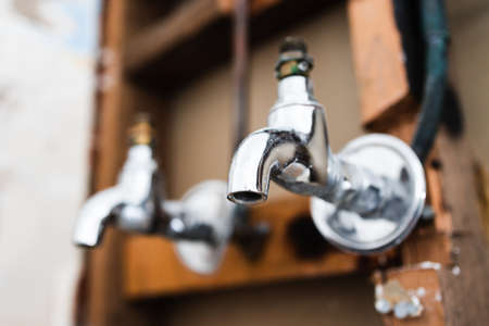 laundry room renovation with plaser walls interior exposed with taps and copper pipes, concept of home renovations and tradesman workの写真素材
