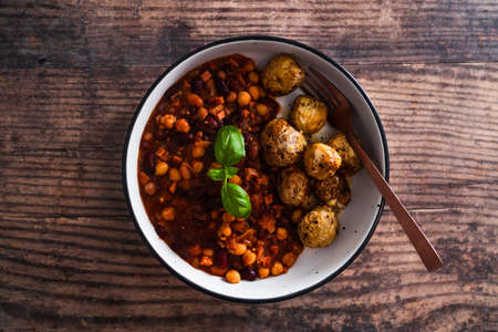vegan bean chilli and roast potatoes, healthy plant-based food recipesの写真素材
