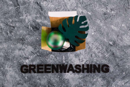 greenwashing and companies pretending to be sustainable conceptual image, paper leaf and green idea...