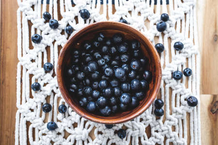 close-up of blueberries in wooden bowl, concept of simple natural healthy ingredients