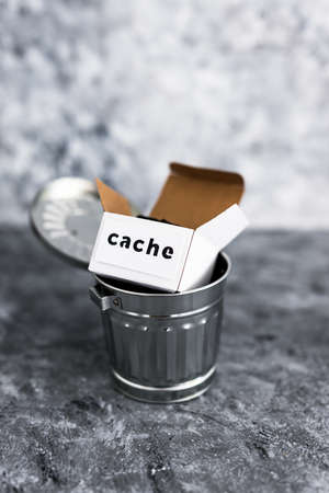 online privacy and stored information concept, metaphor of box with Cache label thrown into recycle...