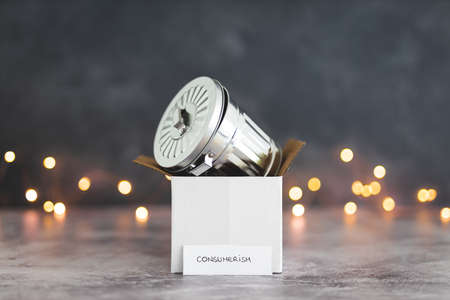 consumerism conceptual image, delivery parcel symbol of goods purchased and recycling bin symbol of...
