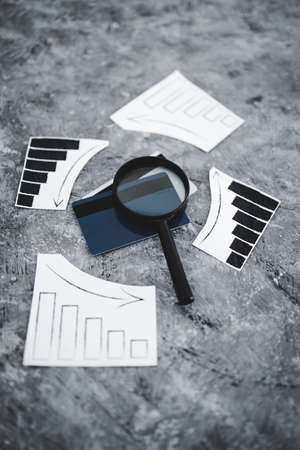 financial markets or money and investments conceptual image, payment cards with charts showing upward and downward trendsの写真素材