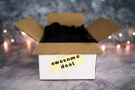 delivery parcel with Awesome Deal label on it and fairy lights in the background, online shopping...