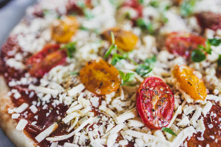 vegan margerita pizza with roasted cherry toatoes and dairy-free cheese, healthy plant-based food recipesの写真素材