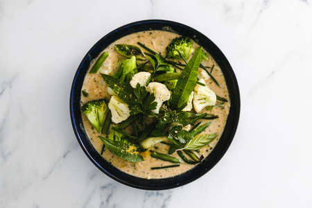 vegan green curry with broccoli cauliflower and green beans, healthy plant-based food recipes