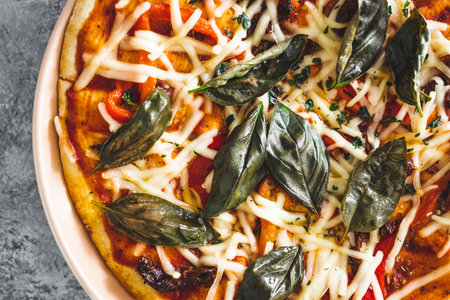 vegan margherita pizza with dairy-free cheese basil toppping and sundried tomatoes, healthy...