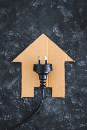 house icon on black with Australian plug on it, concept of electricity bill and power companiesの写真素材