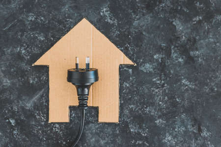 house icon on black with Australian plug on it, concept of electricity bill and power companiesの写真素材