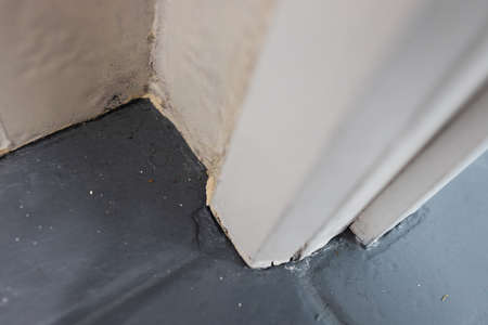 close up of tile flooring and architrave with old worn out materials in need to be fixed, concept of...