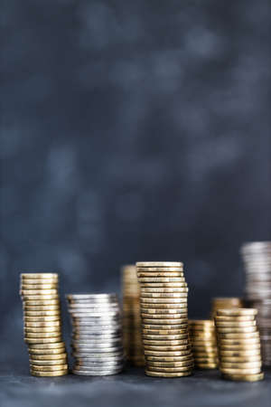 stacks of different golden and silver coins creating a big amount of savings, concept of abundance...