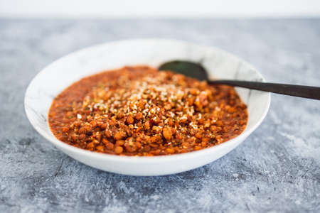 vegan lentil and couscous ragu with herbs and dukkah as topping, healthy plant-based food recipes