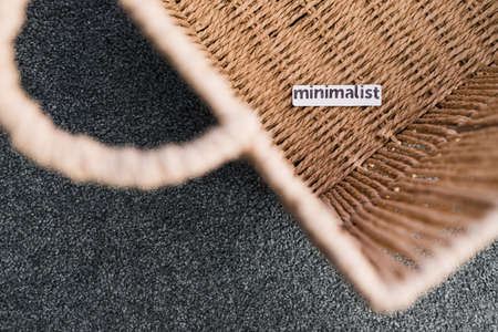 storage basket with Minimalism label on it and nothing inside of it, concept of decluttering and...