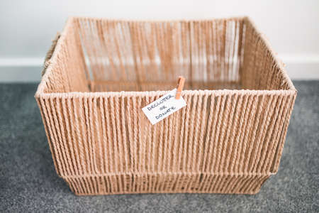 storage basket with Declutter or Donate label on it and nothing inside of it, concept of...