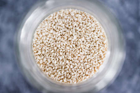 spice jar with sesame seeds close-up shot of pantry ingredients, concept of simple toppings to flavour your dishesの写真素材