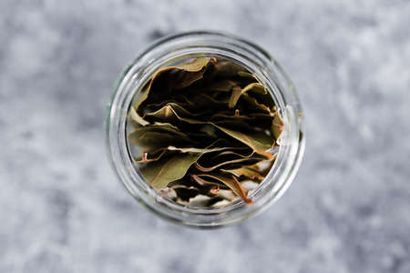 spice jar with bay leaves close-up shot of pantry ingredients, concept of simple toppings to flavour your dishesの写真素材