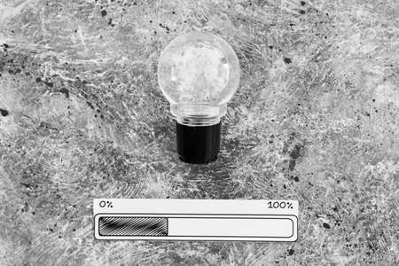 idea light bulb with progress bar beneath it, concept of productivity and innovationの写真素材