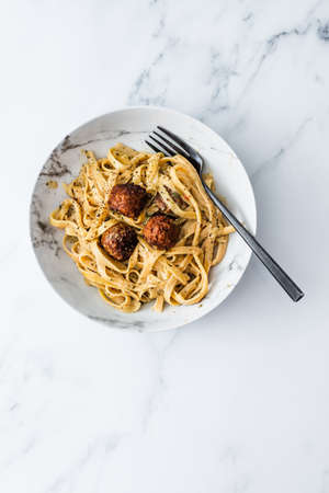 vegan spaghetti noodles with plant-based meatballs and creamy dairy-free sauce, healthy plant-based food recipesの写真素材