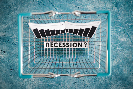recession and stagnating economy conceptual image with text inside of shopping basket with graphs showing stats like growth going down and prices going upの写真素材