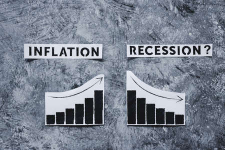 inflation and recession in economy, conceptual image with texts and graphs showing prices going up and growth going downの写真素材