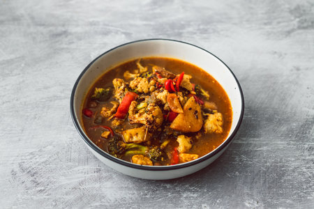 vegetable stew with cauliflower potato broccoli in spicy broth, healthy plant-based food recipesの写真素材