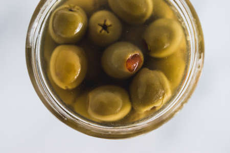 pantry jar with green stuffed olives shot from top down perspective as close-up, simple staple ingredientsの写真素材