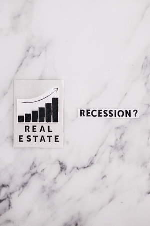 recession text with question mark next to real estate stats going up, concept of post pandemic...