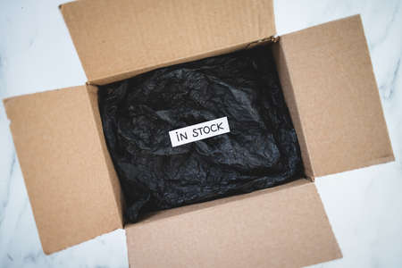 In stock text inside of delivery parcel from online shopping, concept of shopping and retailの写真素材