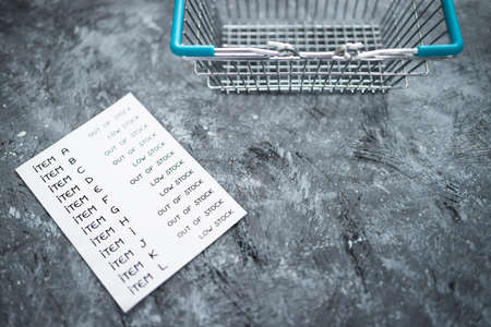 business inventory with every item being Low stock or out of stock next to empty shopping basket, concept of supply chain shortages and delays after the covid-19 global pandemicの写真素材