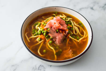 plant-based ramen soup with udon noodles peas and pickled ginger, healthy vegan food recipesの写真素材
