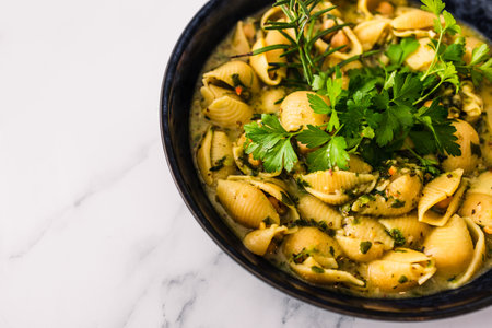 plant-based shell pasta with chickpeas and spinach in creamy sauce, healthy vegan food recipesの写真素材