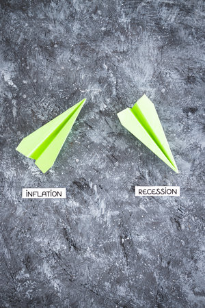 inflation and recession texts on paper planes going up and down, concept of economic struggles after...