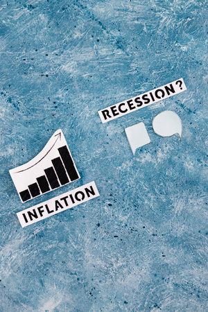 inflation text and graph showing prices going up next to recession text with comic bubbles symbol of different opinions next to it, concept of economic struggles after the pandemicの写真素材