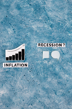 inflation text and graph showing prices going up next to recession text with comic bubbles symbol of different opinions next to it, concept of economic struggles after the pandemicの写真素材