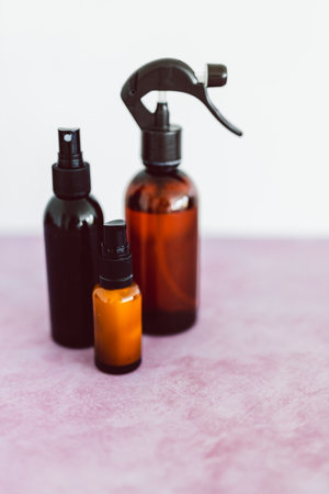 natural beauty and organic ingredients in skincare, apothecary skincare bottles and scent spray on pink backgroundの写真素材