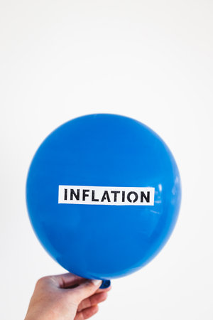 inflation text on top of big inflated balloon, funny conceptual image about the post-pandemic economyの写真素材