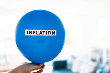 inflation text on top of big inflated balloon, funny conceptual image about the post-pandemic...
