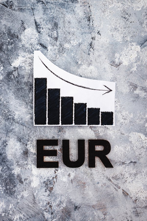 currency exchange rate conceptual image, graph showing negative growth with EUR text underneath it symbol of performance on the global stock marketsの写真素材