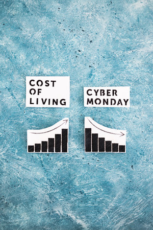 Cost of Living vs Cyber Monday conceptual image with graphs showing price going up and consumer spending going downの写真素材