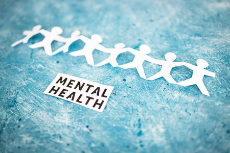 Menatal health text next to paper people chain, concept of psychology and need for helpの写真素材