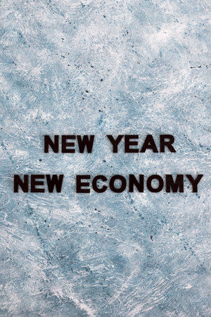 new year new economy text on grey blue background