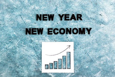 new year new economy text with graphs showing growth stats going  up again on grey blue background