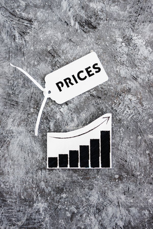 inflation and cost of living conceptua image, Prices text on product tag next to graph with stats up