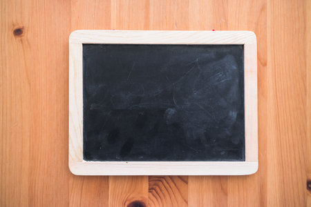 small blackboard with blank copy space on top of wooden table, space to add your text