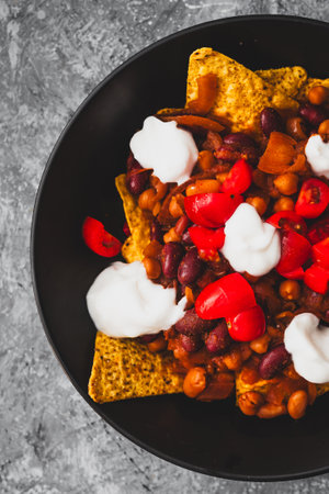 healthy  bean nachos with tomato salsa and coconut yoghurt, healthy vegan food recipesの写真素材