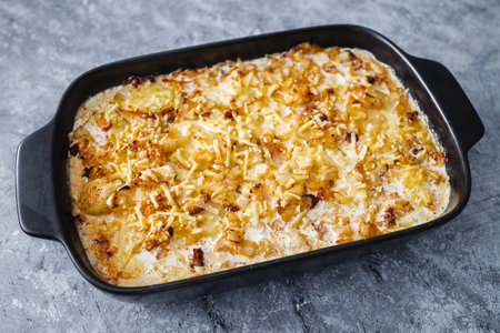 cheesy creamy potato bake before going in the oven , vegetarian food recipesの写真素材