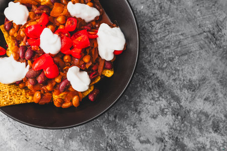 healthy  bean nachos with tomato salsa and coconut yoghurt, healthy vegan food recipesの写真素材