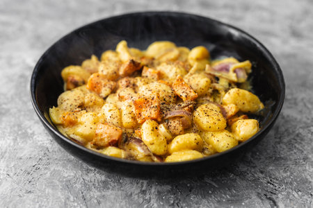 turmeric gnocchi with pumpkin and onion in creamy sauce, healthy plant-based food recipesの写真素材
